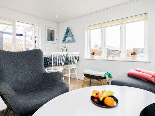 a living room with a table and two chairs and a table at 4 person holiday home in Assens in Assens