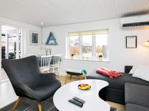 a living room with a couch and a table at 4 person holiday home in Assens in Assens