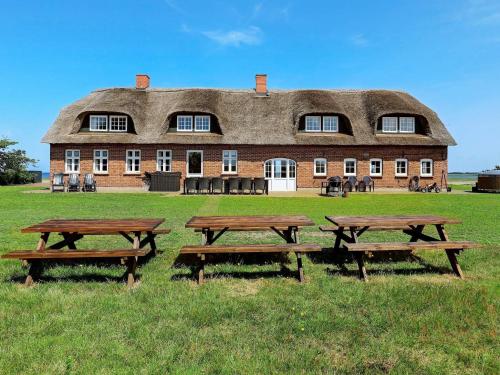 a large building with picnic tables in front of it at 20 person holiday home in Ulfborg in Ulfborg