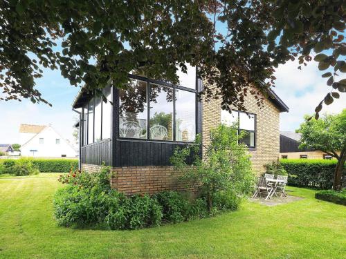 a house with a large window on the side of it at 6-Person Holiday Home in Strandby in Strandby