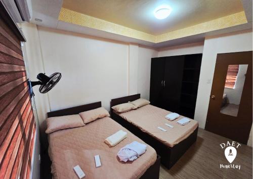Ένα ή περισσότερα κρεβάτια σε δωμάτιο στο Daet HomeStay