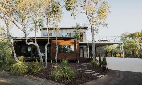 a house with a wooden facade with trees at Palmiera Escape - Luxury, laid-back holiday home in Margaret River in Margaret River Town