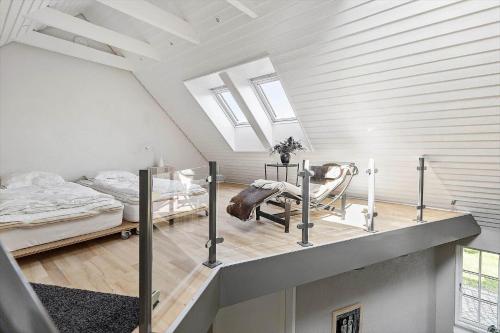 a attic room with a bed and a table at 5605-Ostermarie-Havrehojvej-10 in Østermarie