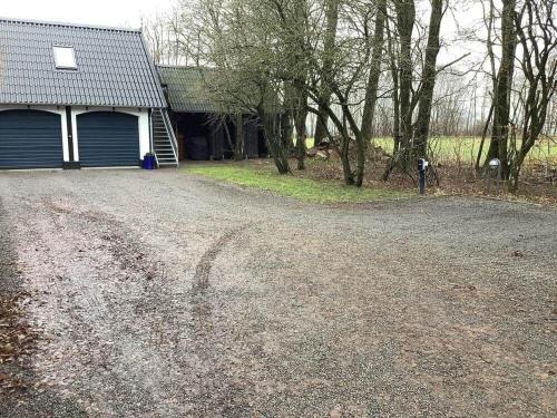 a dirt road in front of a house at 5605-Ostermarie-Havrehojvej-10 in Østermarie