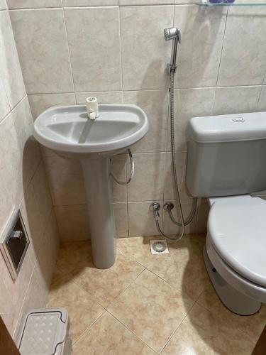 a bathroom with a toilet and a sink at Cantinho Perfeito in Belém