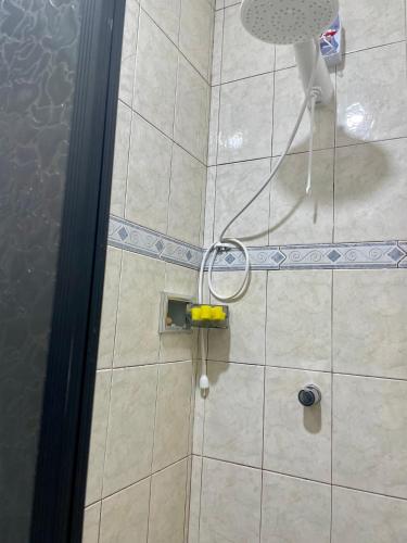 a shower with a shower head in a bathroom at Cantinho Perfeito in Belém