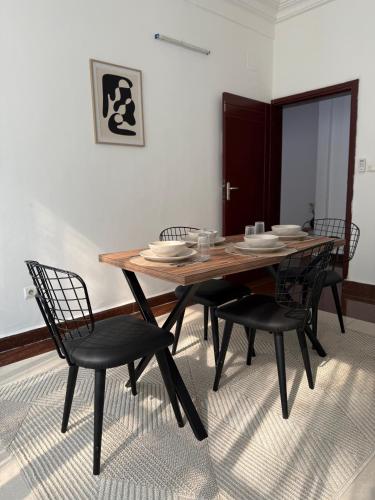 a dining room table and chairs in a room at Satya in Motsouémbé