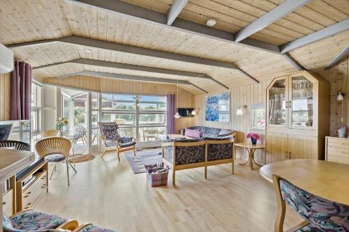 a living room with a table and chairs at 6812-Allinge-Astelokken-10 in Allinge