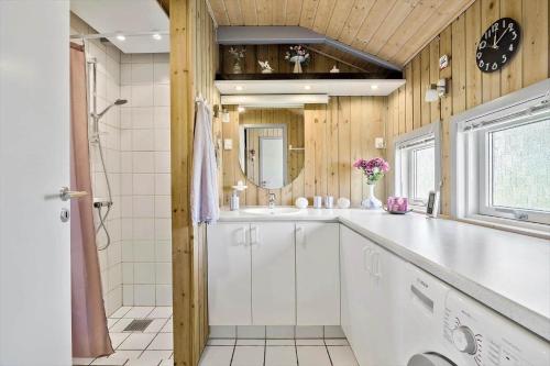 a bathroom with a white sink and a shower at 6812-Allinge-Astelokken-10 in Allinge