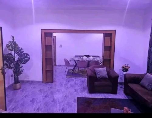 a living room with a table and a couch at Villa meublé Express in Niamey
