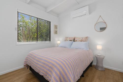 Ένα ή περισσότερα κρεβάτια σε δωμάτιο στο Palm Hideaway