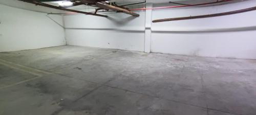 an empty room with white walls and a concrete floor at Flat Brisa do Mar - Centro Porto - 300 metros das piscinas naturais in Porto De Galinhas