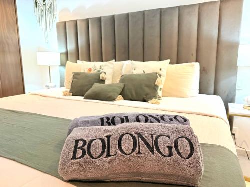 a bedroom with a bed with aounding boloco sign on it at Bolongo 3BR your exclusive oceanfront escape in Punta Mita
