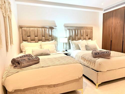 a bedroom with two beds with pillows on them at Bolongo 3BR your exclusive oceanfront escape in Punta Mita