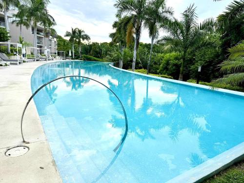a large blue swimming pool with a hoop in the middle at Bolongo 3BR your exclusive oceanfront escape in Punta Mita