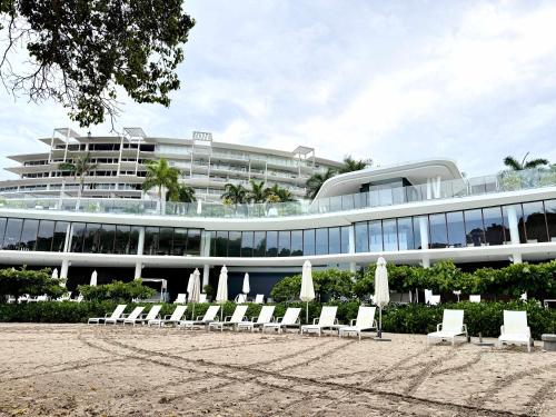 a building with chairs and umbrellas in front of it at Bolongo 3BR your exclusive oceanfront escape in Punta Mita