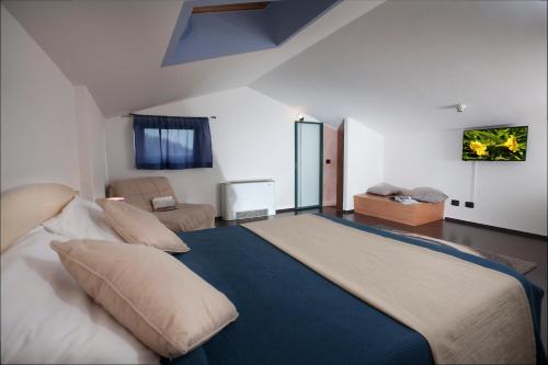 a bedroom with a large bed in a room at Taki Village in Brenzone sul Garda