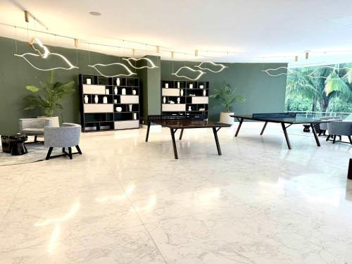 a room with a ping pong table and chairs at Bolongo 3BR your exclusive oceanfront escape in Punta Mita
