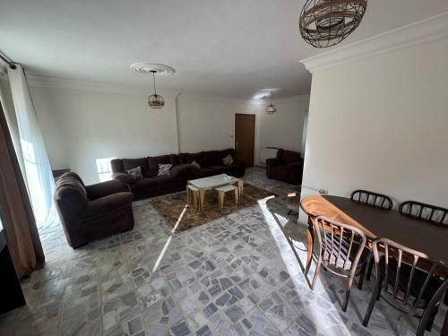a living room with a couch and a table at sahari-2 in Amman