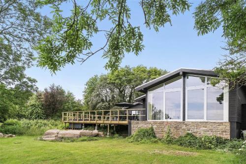 a modern house with glass doors and windows at 5528-Svaneke-Urmarken-35 in Svaneke