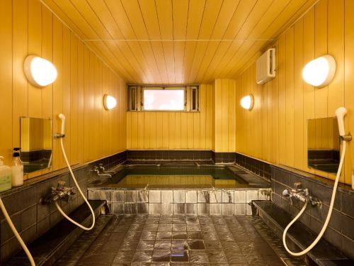 a bathroom with a bath tub in a room at Hotel Wakamizu in Chino