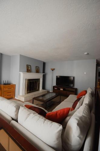 a living room with a white couch with red pillows at Bright and Peaceful Apt in Midvale in Midvale