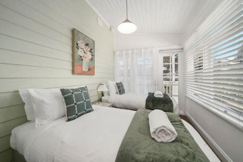 a bedroom with two beds and a window at Inchcolm in Leura