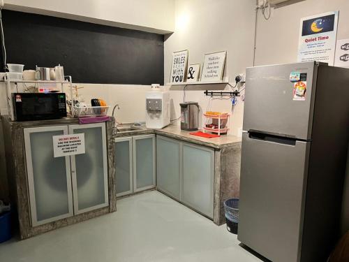 a kitchen with a stainless steel refrigerator in a room at Sunshine House in George Town