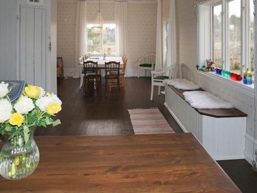 a living room with a vase of flowers on a table at Pleasant holiday home for 8 guests in Vimmerby