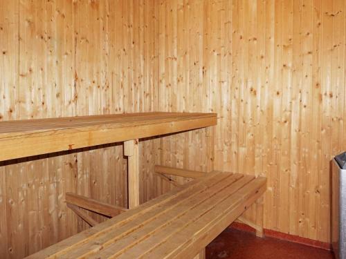 a wooden sauna with two wooden benches in it at Pleasant holiday home for 8 guests in Vimmerby