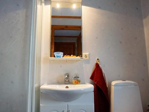 a bathroom with a sink and a mirror and a toilet at 5 person holiday home in Bullaren-By Traum in Bullaren