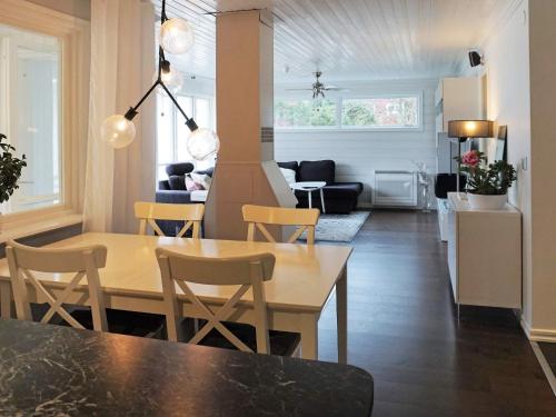 a dining room and living room with a table and chairs at 5 person holiday home in Nösund in Nösund