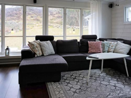 a living room with a couch and a table at 5 person holiday home in Nösund in Nösund