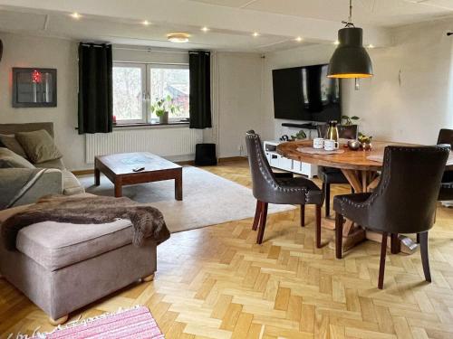 a living room with a table and a couch at 5 person holiday home in LÖDDEKÖPINGE in Löddeköpinge