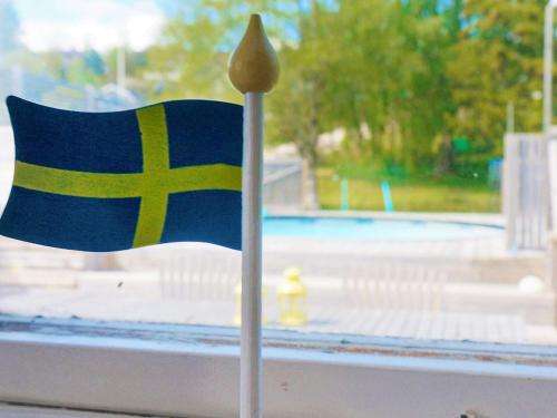 a small flag on a toothpick in front of a window at 8 person holiday home in BILLINGSFORS in Billingsfors