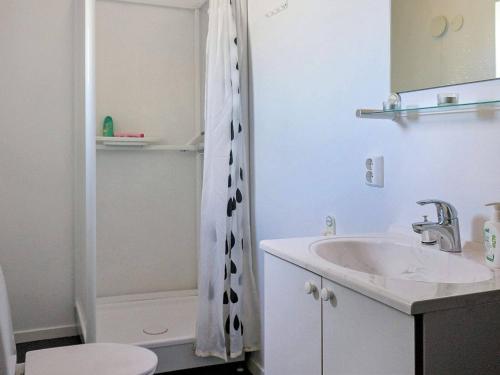 a white bathroom with a sink and a shower at 8 person holiday home in BILLINGSFORS in Billingsfors