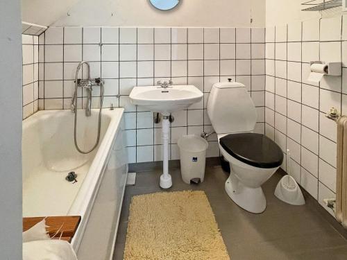 a bathroom with a sink and a toilet and a bath tub at 5 person holiday home in LINNERYD KRONOBERGS LÄN in Linneryd