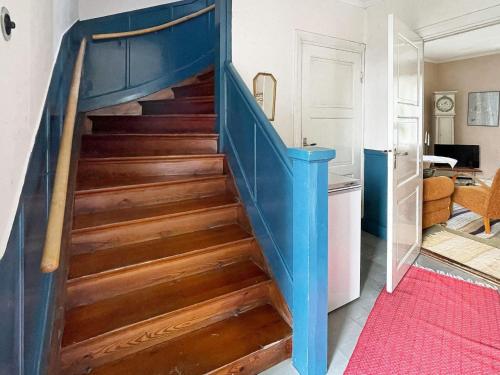 a blue staircase in a living room with a red rug at 5 person holiday home in LINNERYD KRONOBERGS LÄN in Linneryd