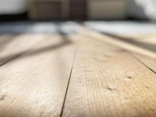 a close up of a wooden table with a shadow on it at 5 person holiday home in LINNERYD KRONOBERGS LÄN in Linneryd