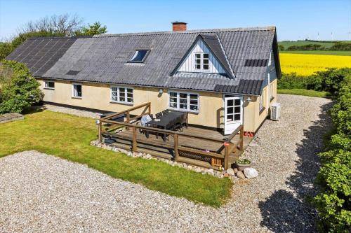 a small yellow house with a porch and a yard at LF10304-Hurup-Thy-Gundtoft-Mollevej-4 in Gettrup