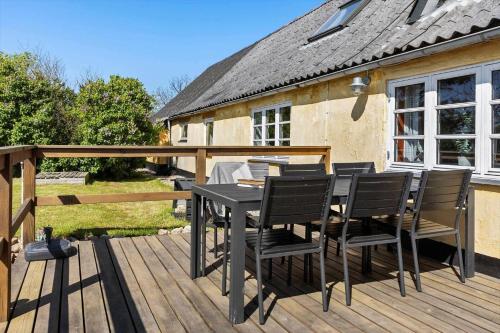 a black table and chairs on a wooden deck at LF10304-Hurup-Thy-Gundtoft-Mollevej-4 in Gettrup