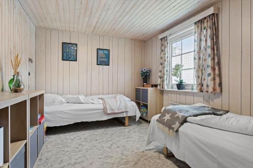 a bedroom with two beds and a window at HA286-Saeby-Nellemannsvej-12 in Sæby