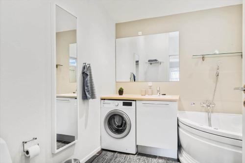 a white bathroom with a washing machine and a sink at HA318-Hals-Merkurvej-73 in Hals