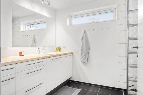 a white bathroom with a shower and a sink at HA318-Hals-Merkurvej-73 in Hals
