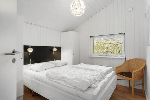 a white bedroom with a large bed and a window at OH551-Hadsund-Ved-Fruerlund-35 in Hadsund