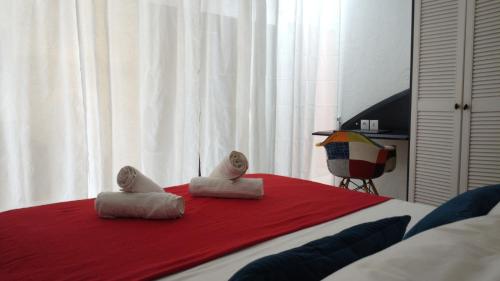 a bedroom with a bed with two pillows on it at L'Escapade - séjour romantique à Marie-Galante, calme, plage à deux minutes à pied in Grand-Bourg