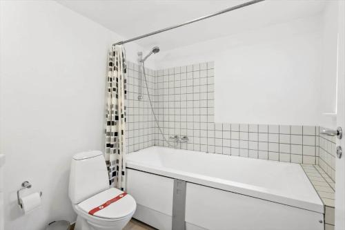 a white bathroom with a tub and a toilet at FY342-Martofte-Fynshovedvej-854-H in Martofte