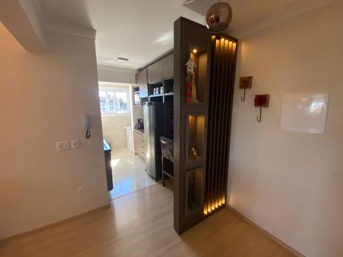 a hallway with a door with lights on it at 2 suítes - 7 lugares, sua família prox Catedral de Pedra in Canela