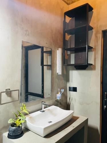a bathroom with a sink and a mirror at Fair View Cottage in Ella