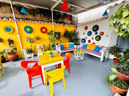 a room with colorful chairs and tables in a room at Hotel y Arte Antigua by Amazing Guatemala Travel in Antigua Guatemala
